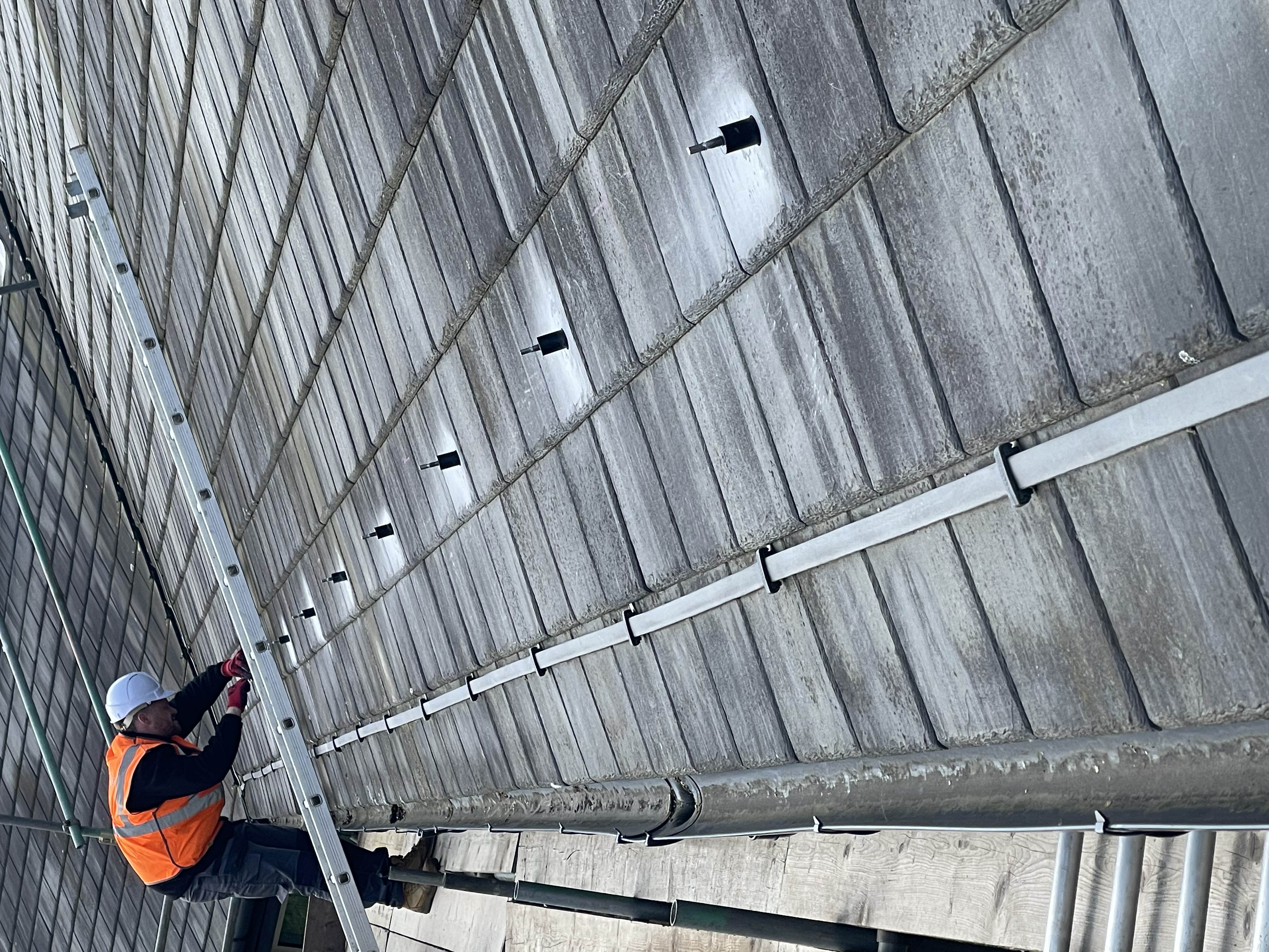 Eight SolVe Mounts installed in a row on a Cambrian interlocking slate roof — NHS Trust project
